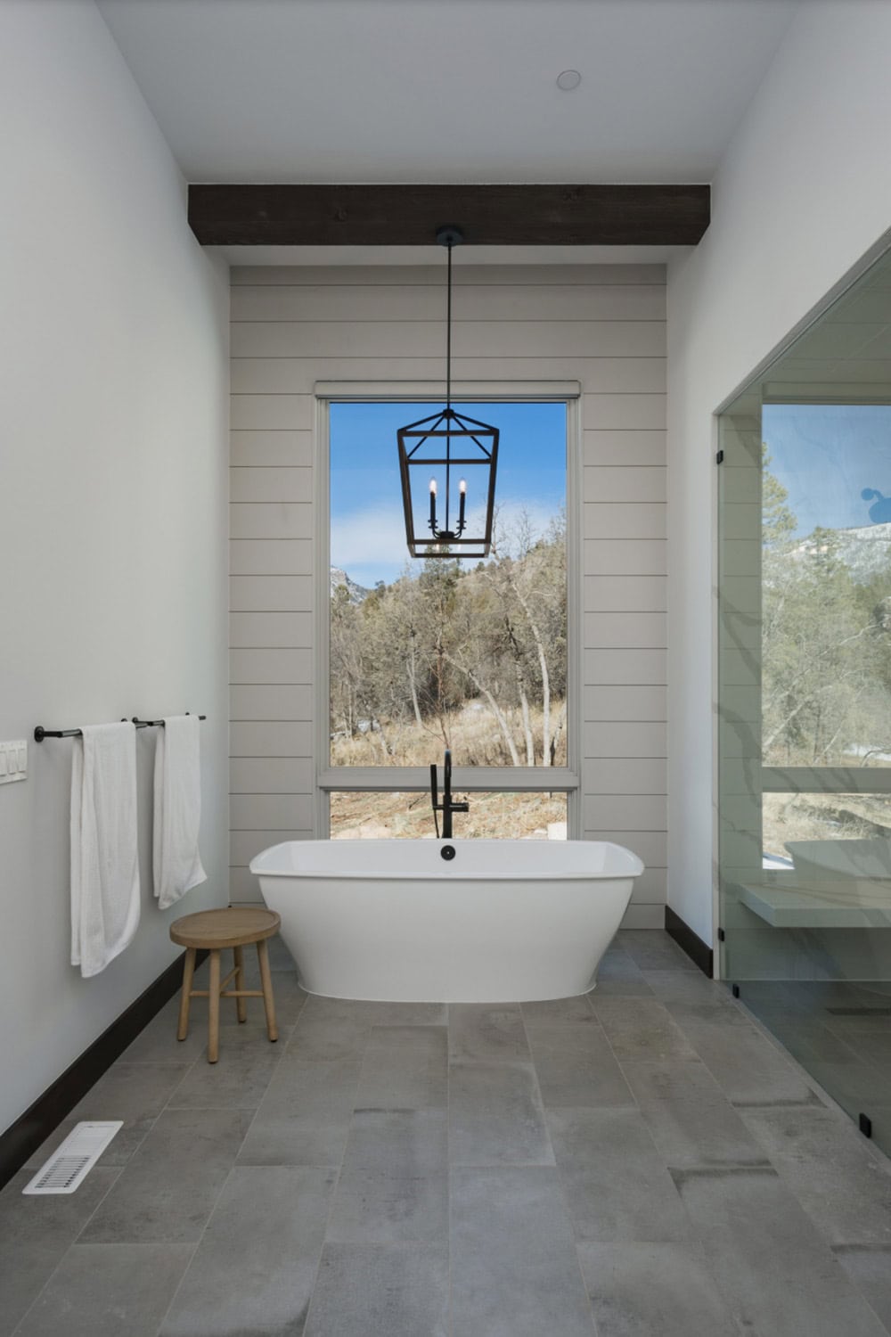 rustic bathroom with a freestanding tub and shower