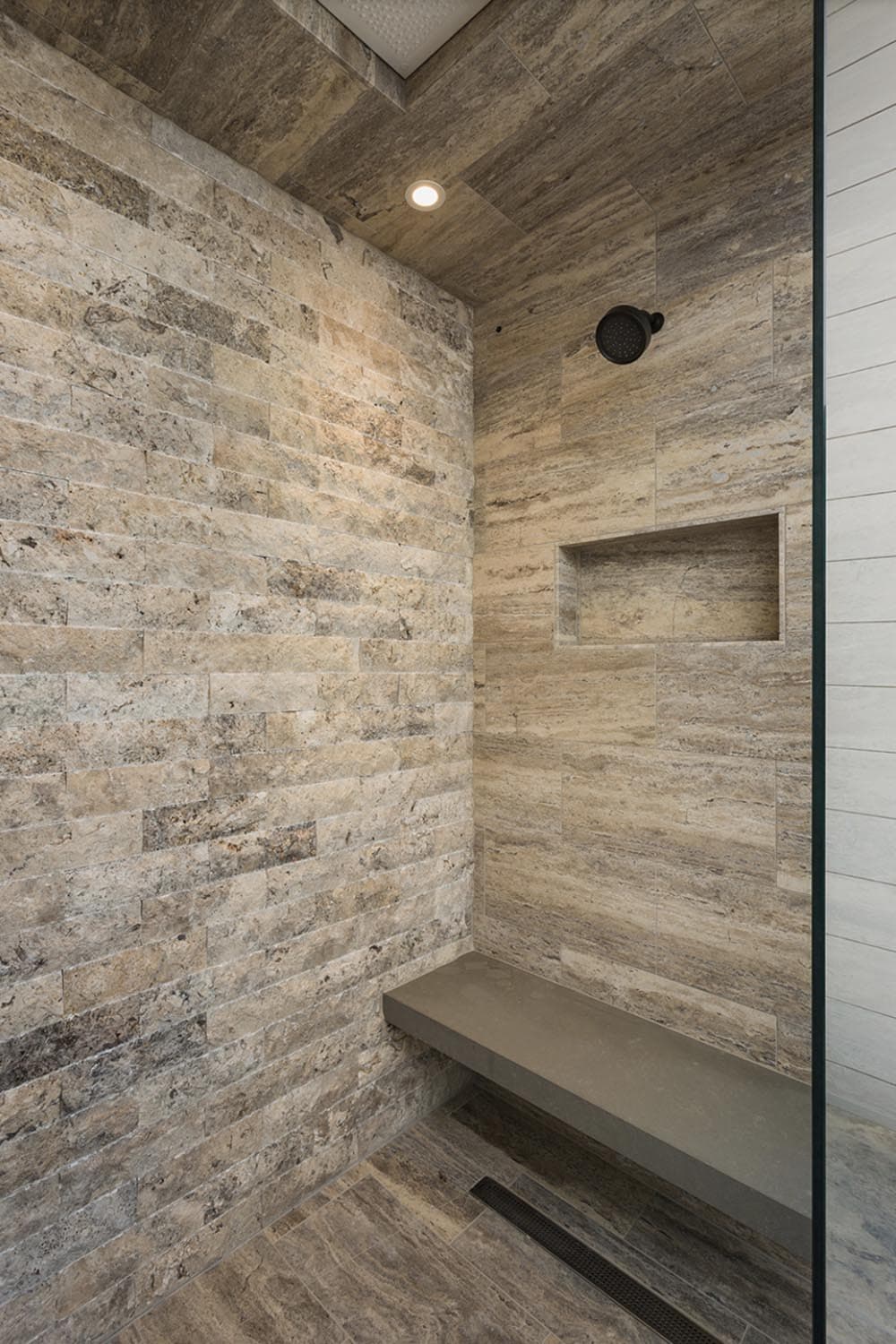 rustic bathroom shower with a bench