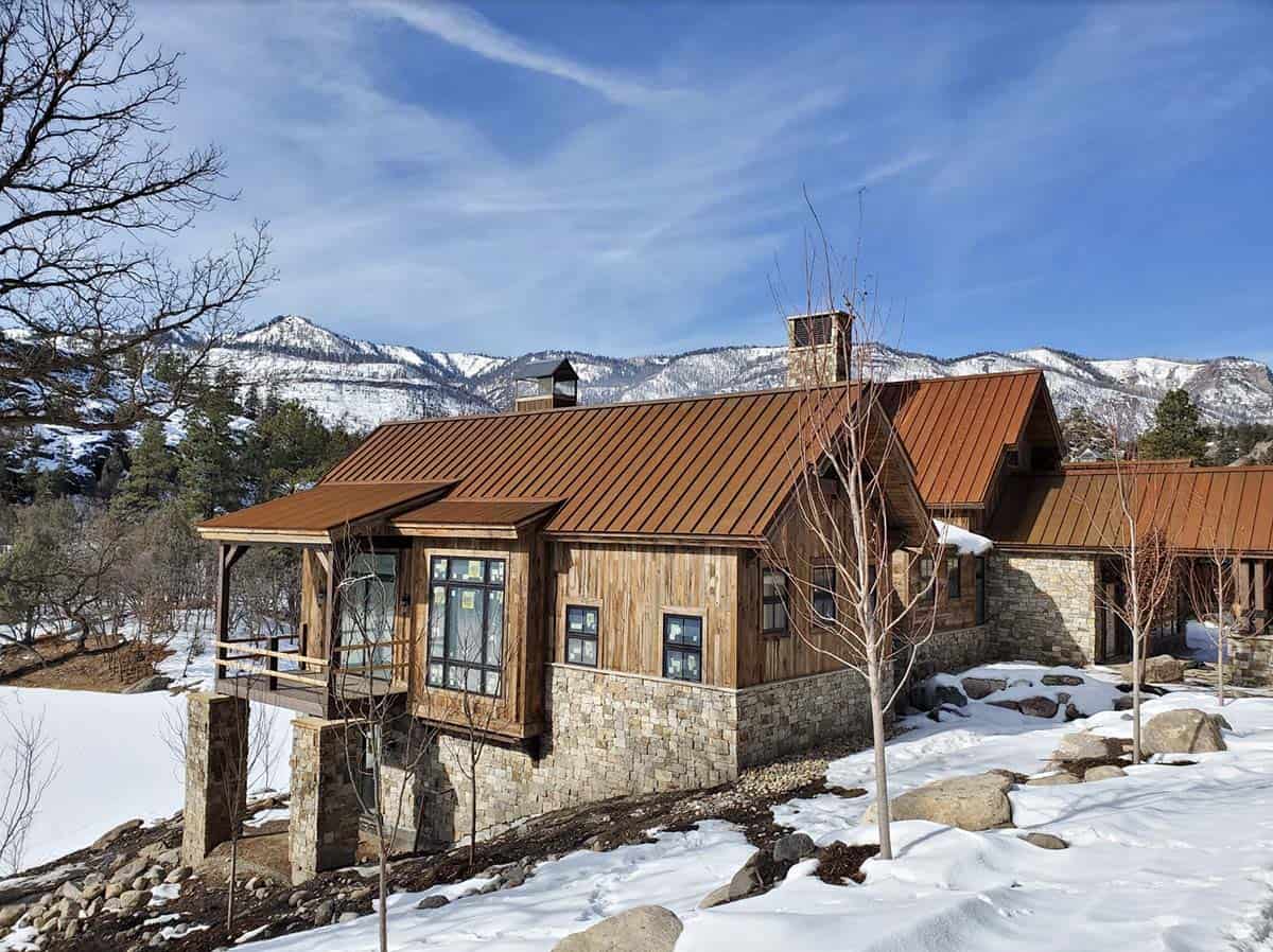 timber frame mountain house exterior with snow