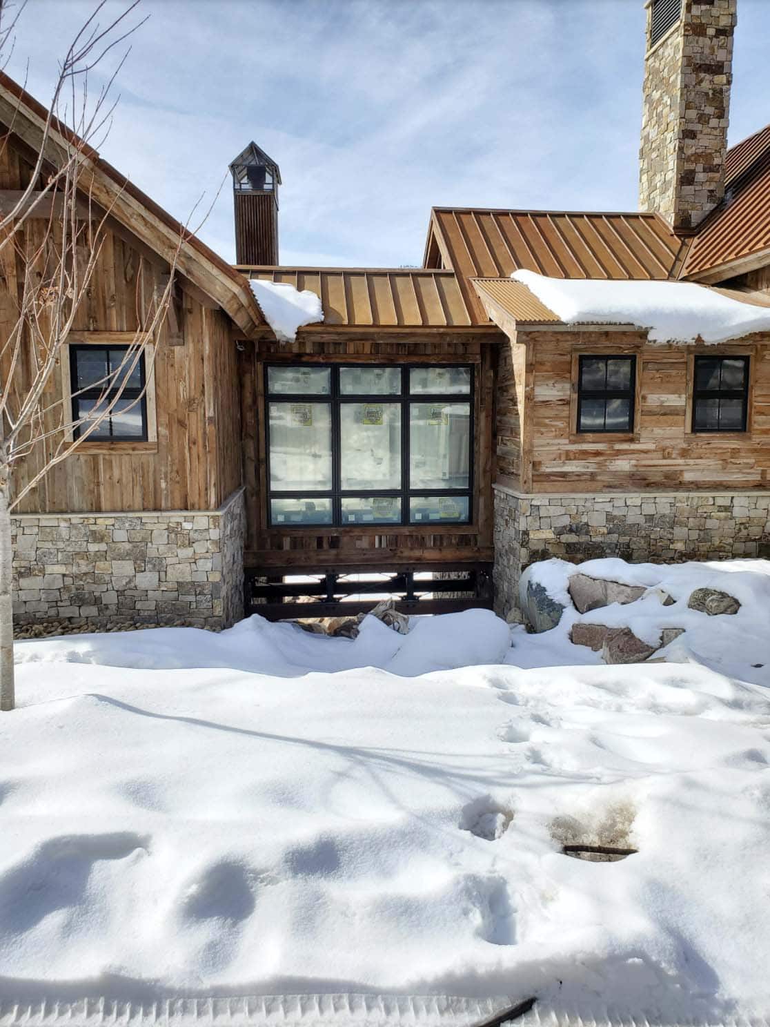 timber frame mountain house exterior with snow