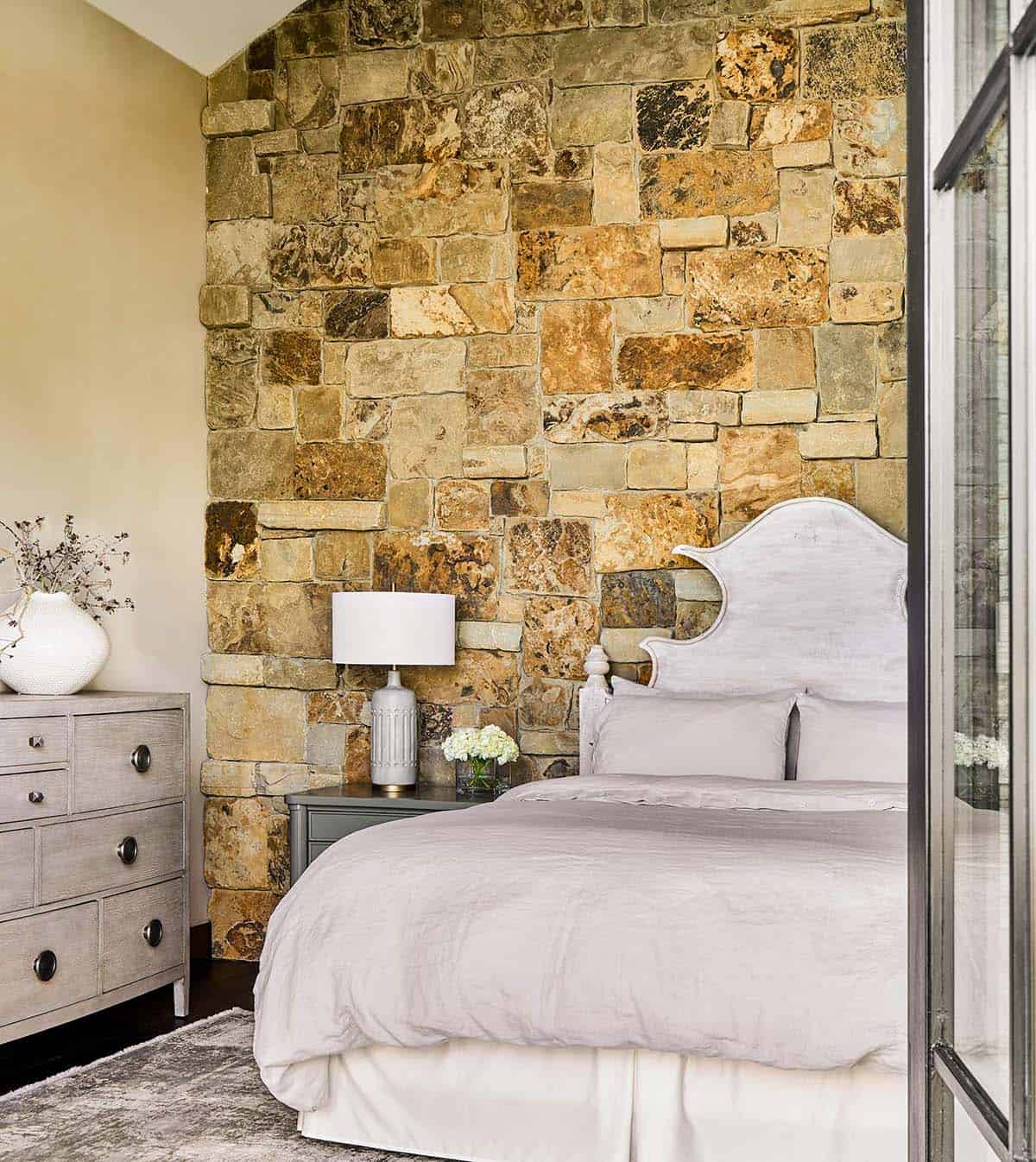 modern rustic bedroom with a stone accent wall