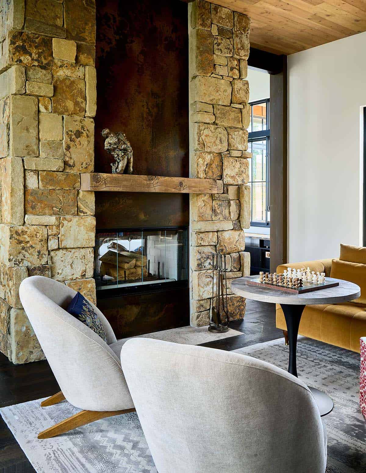 modern rustic living room with a dual sided fireplace