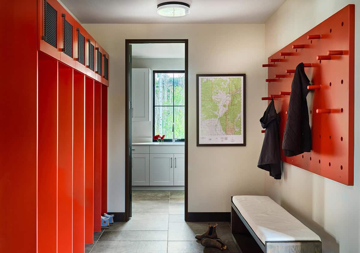 modern rustic mudroom with a bench and storage cubbies painted red