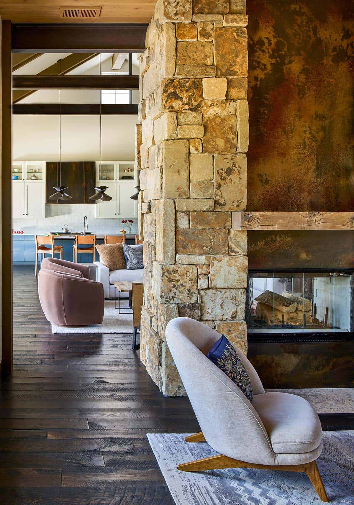 modern rustic living room with a dual sided fireplace