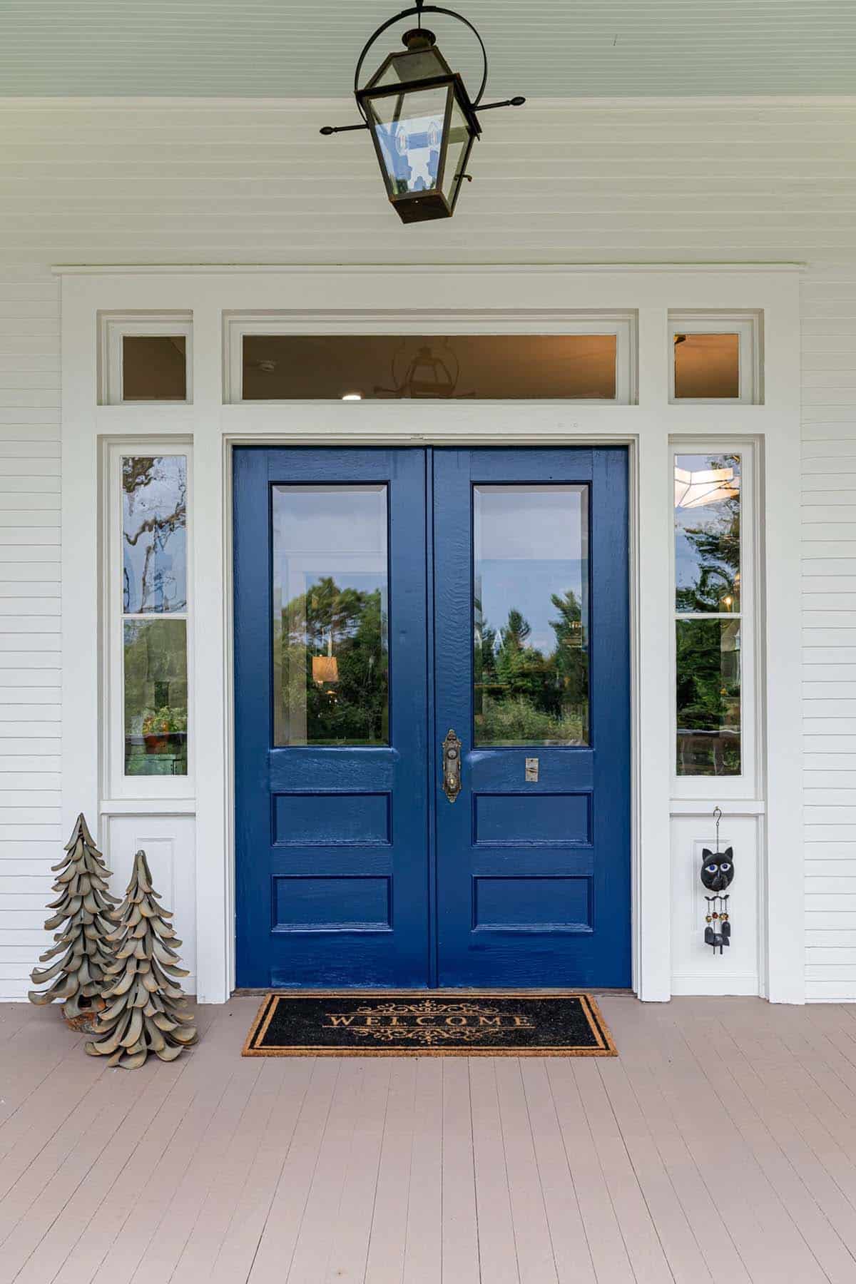 alpine farmhouse exterior entry with blue front doors