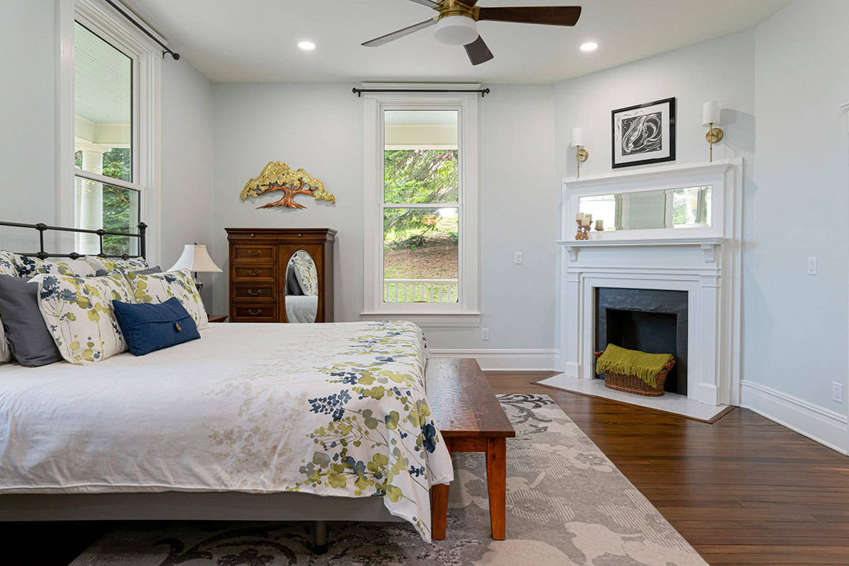 farmhouse style bedroom with a fireplace