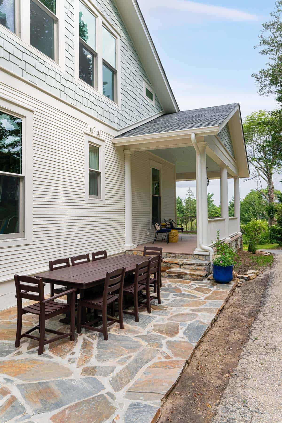 alpine farmhouse exterior backyard patio with alfresco dining