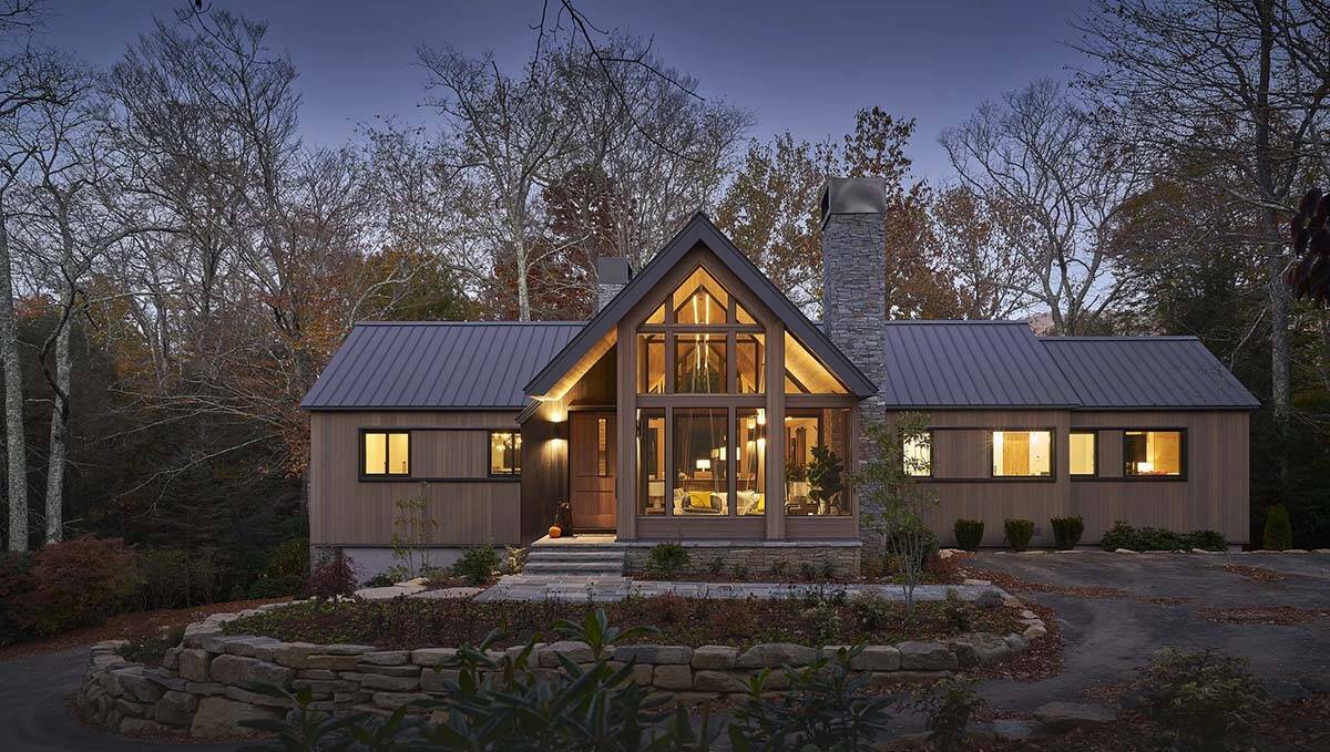 rustic modern mountain home exterior at dusk