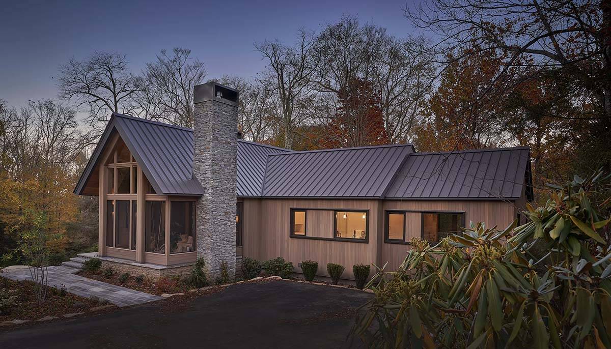 rustic modern mountain home exterior at dusk