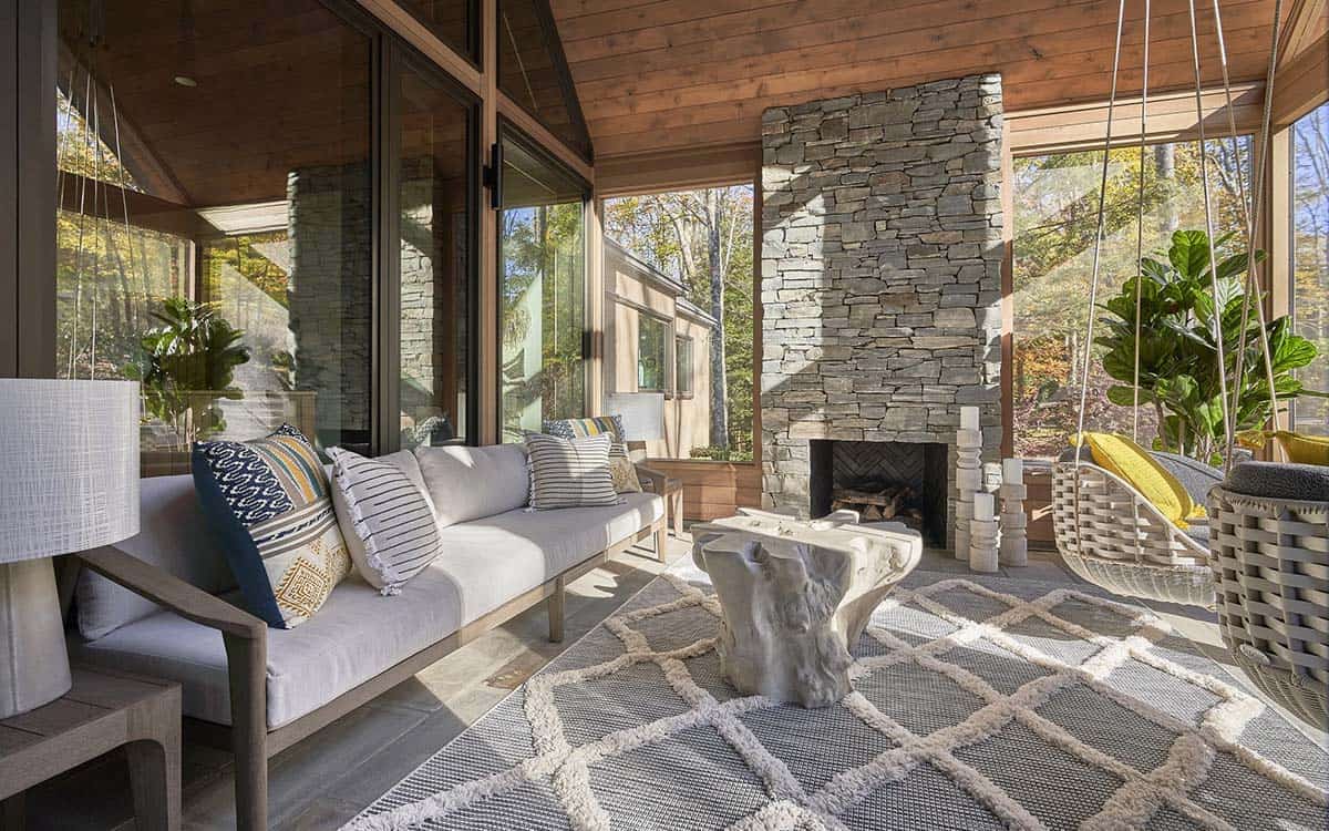 rustic modern screened porch with a fireplace