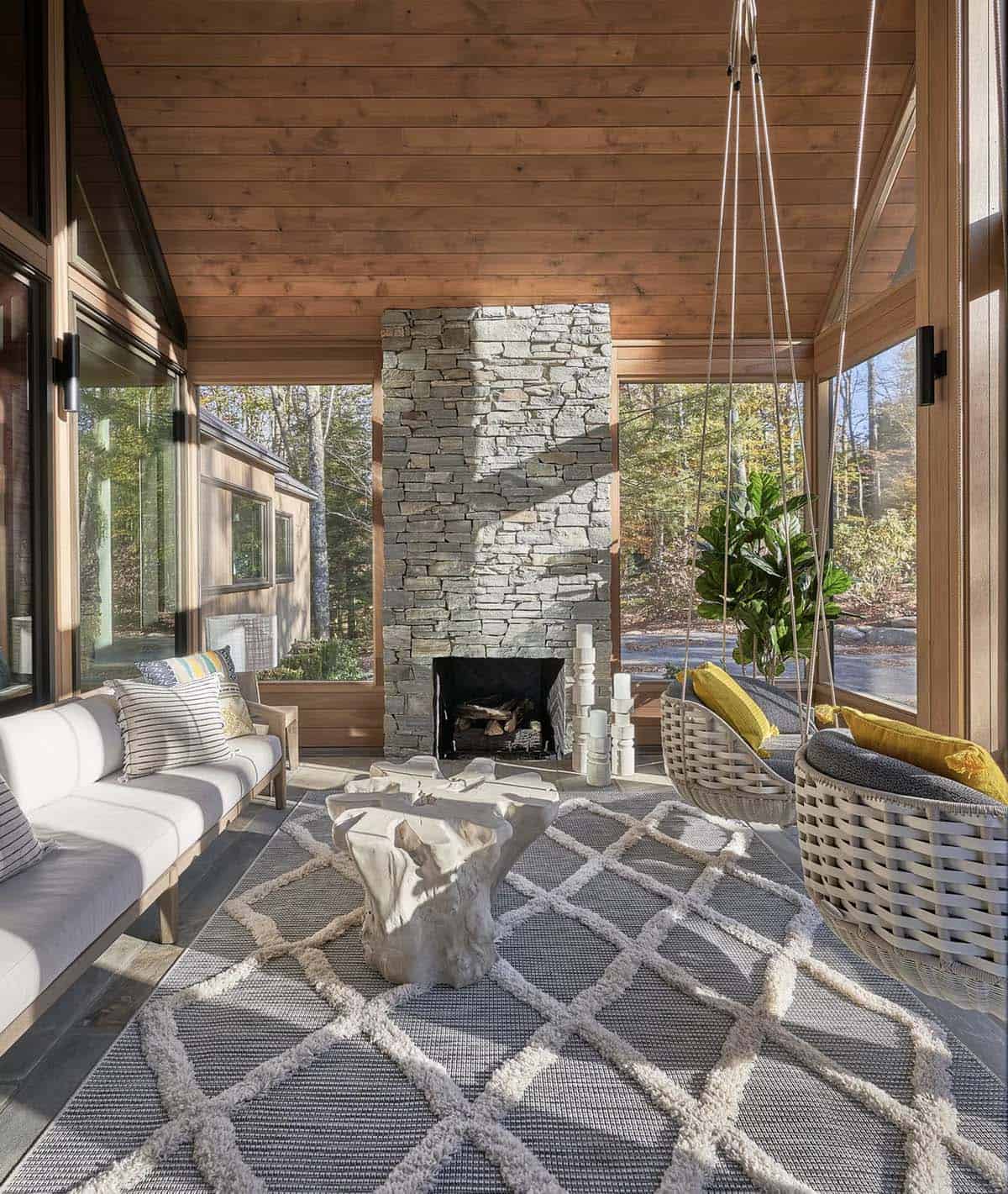 rustic modern screened porch with a fireplace