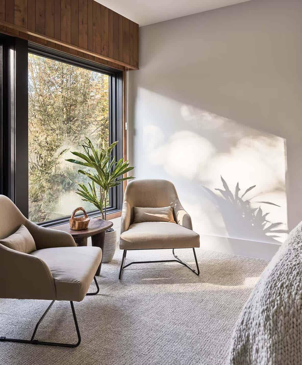 rustic modern bedroom with a pair of chairs