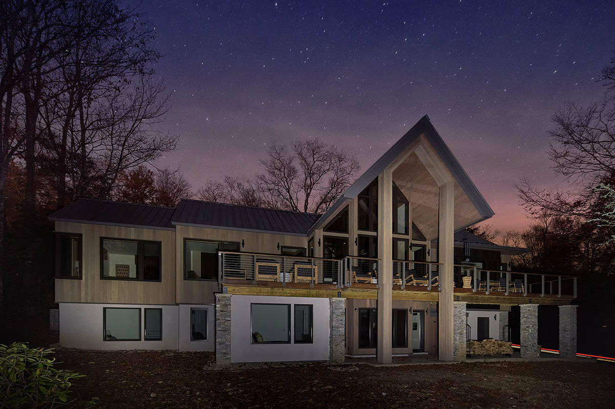rustic modern mountain home exterior at dusk