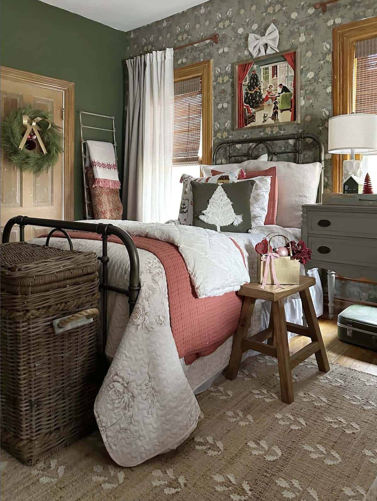 cozy christmas bedroom decor with layers of bedding and a wreath on the door