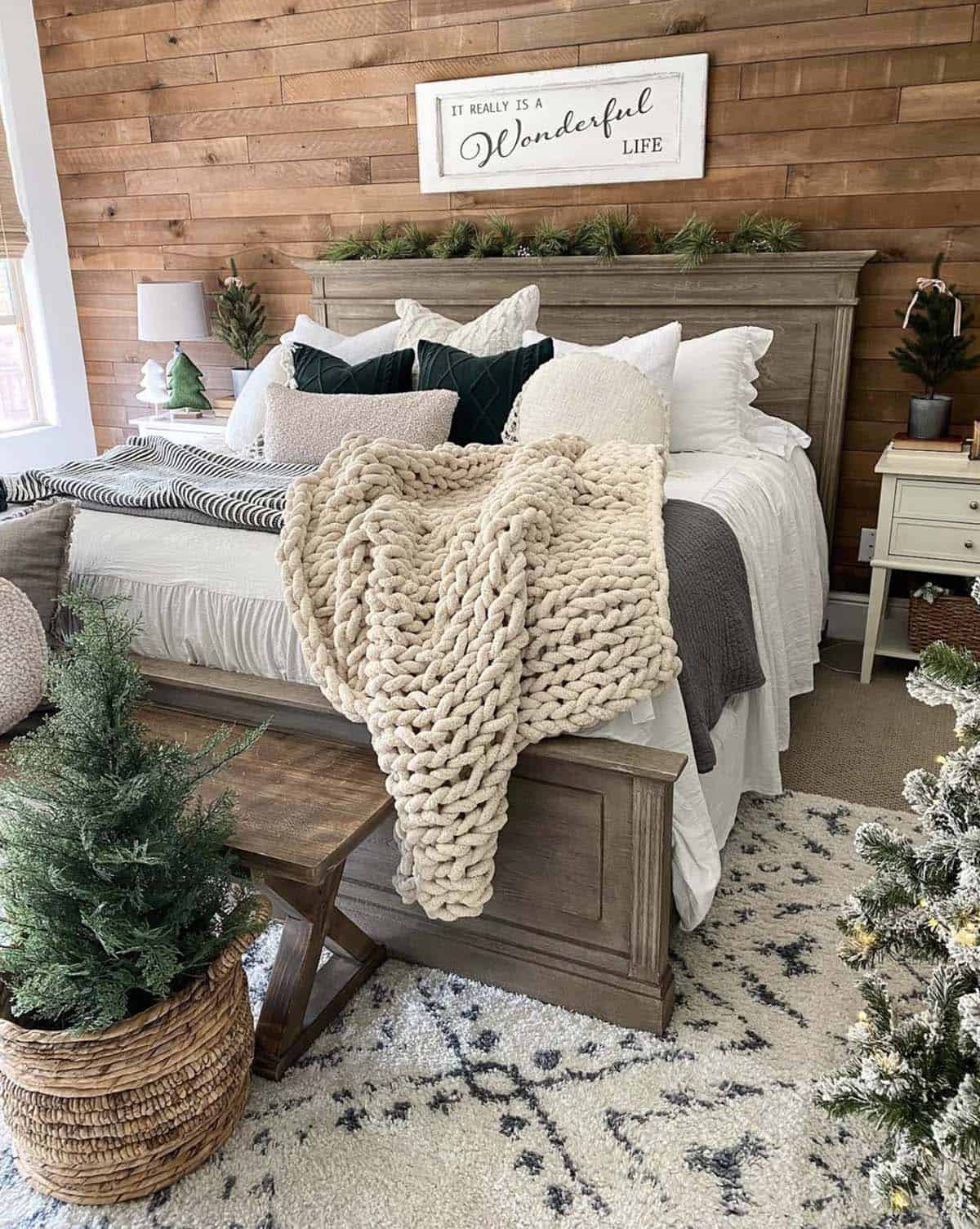 cozy christmas bedroom decor with layers of bedding and a small tree