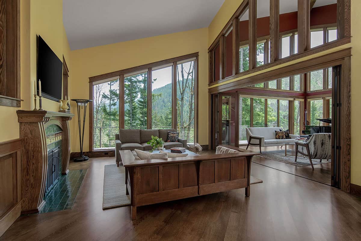 craftsman style open living room with a custom fireplace