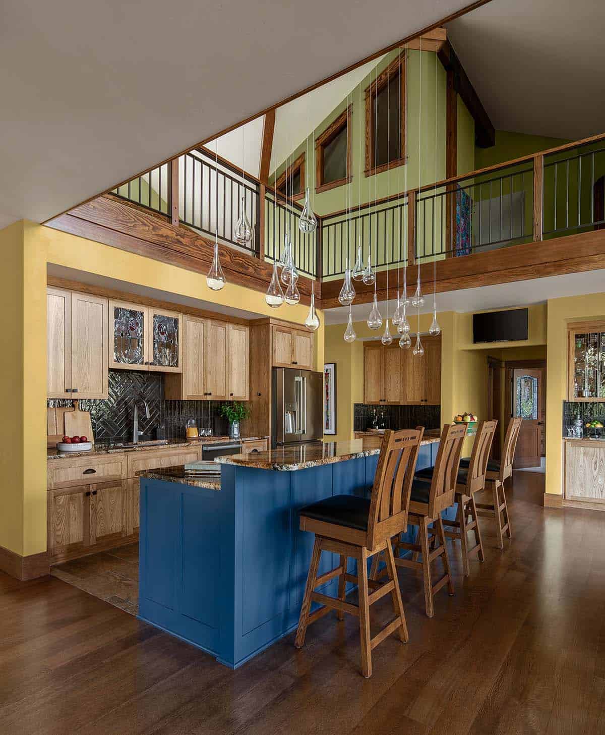 craftsman style open kitchen design with loft above