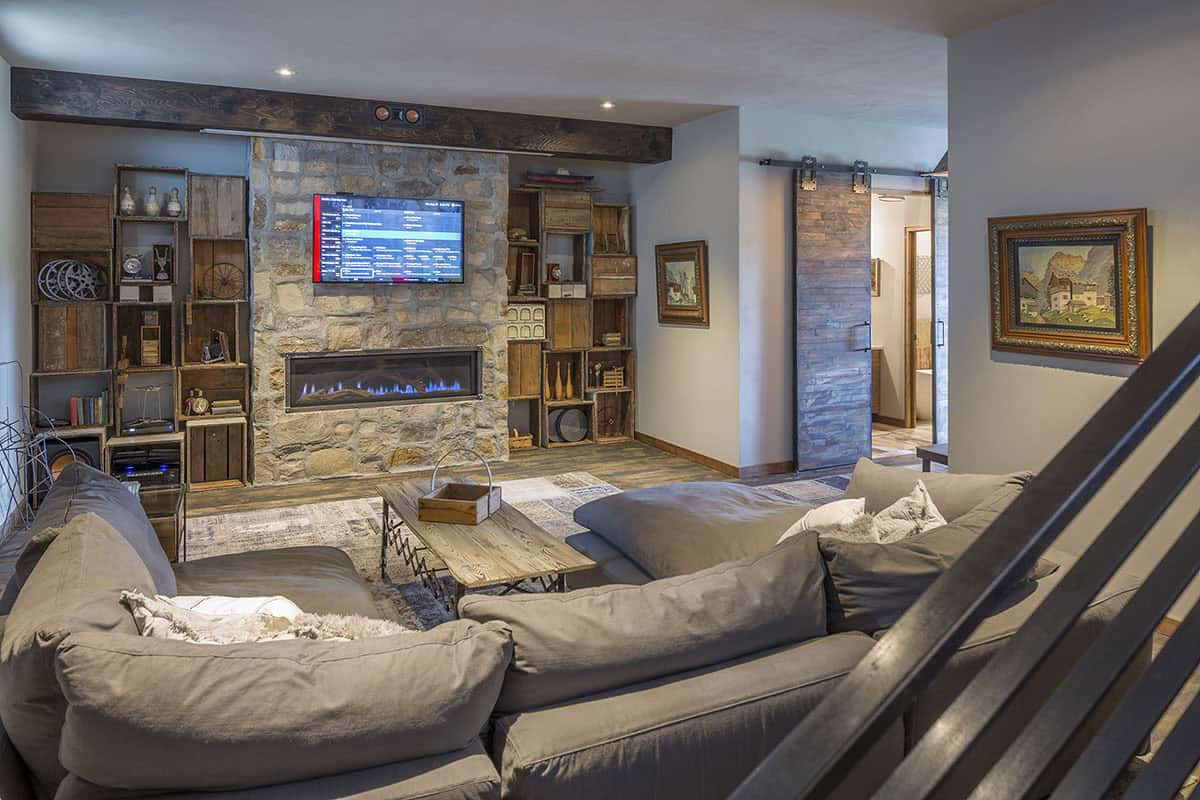 rustic lower-level family room with a fireplace