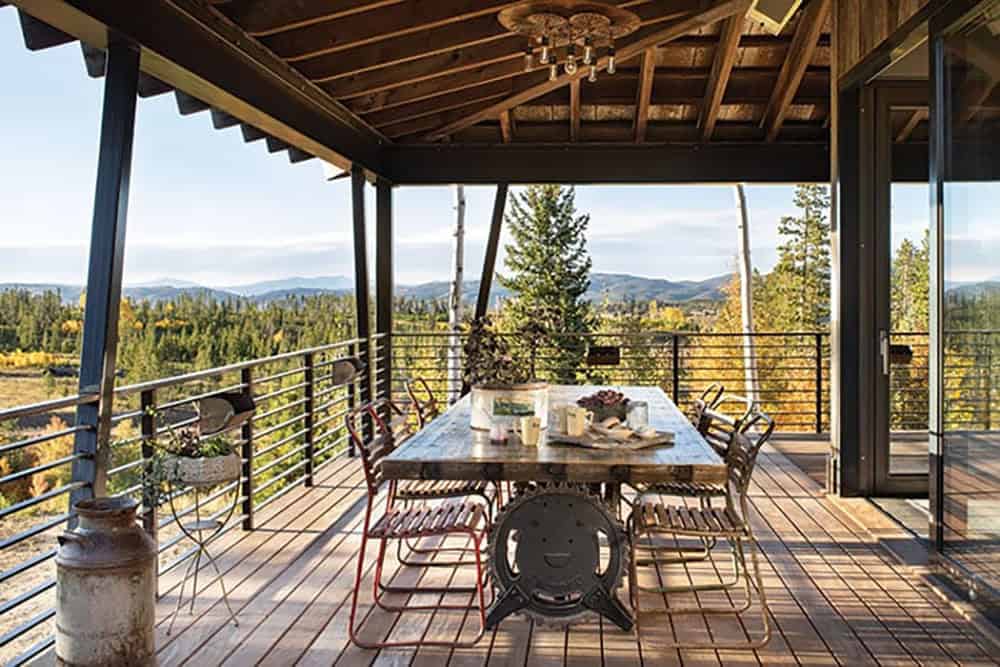 rustic covered deck with outdoor dining