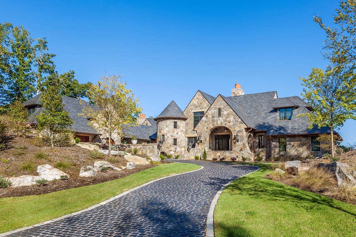 european-inspired home exterior with a long driveway