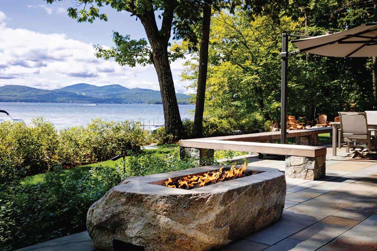 lake house exterior patio with a fire pit