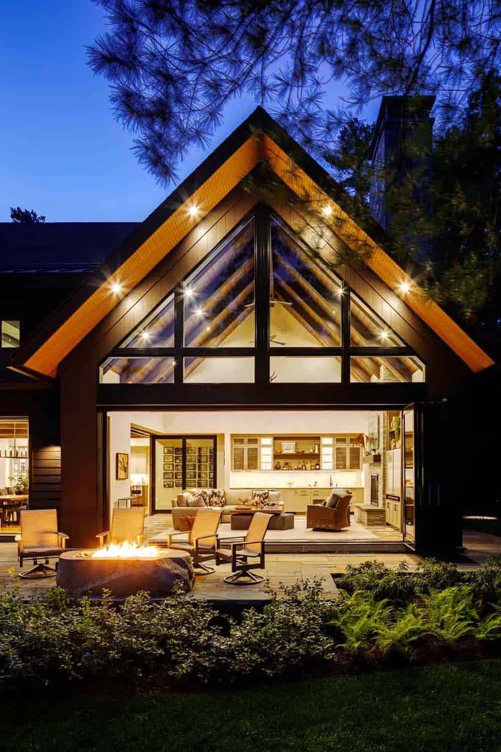 lake house exterior with a fire pit at dusk