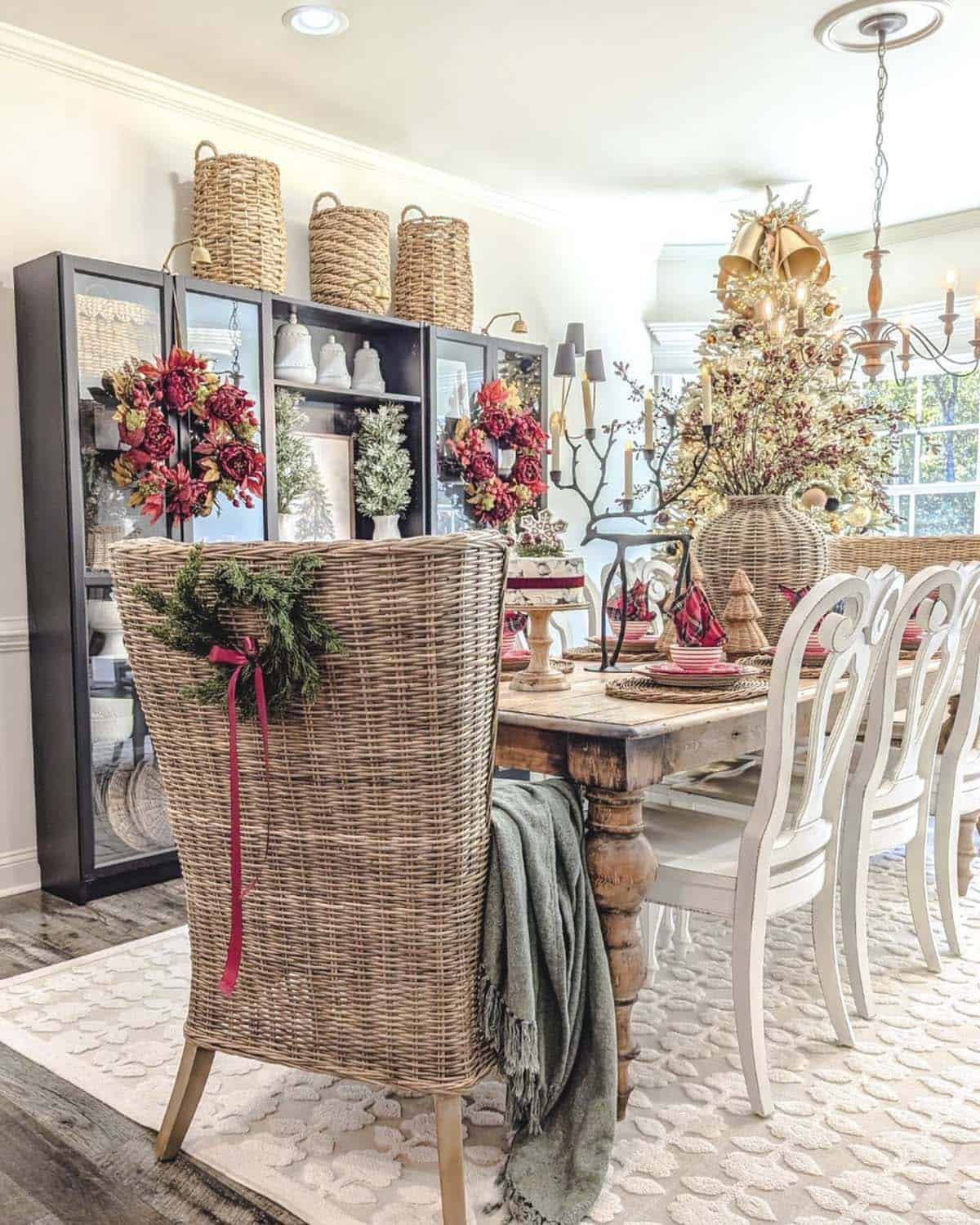 christmas decorated dining table with a wreath on the back of the end chair