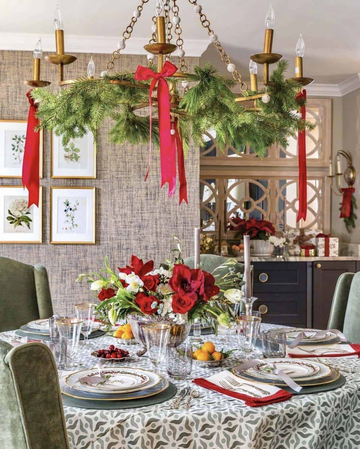 christmas dining table chandelier with swags of greenery and red bows