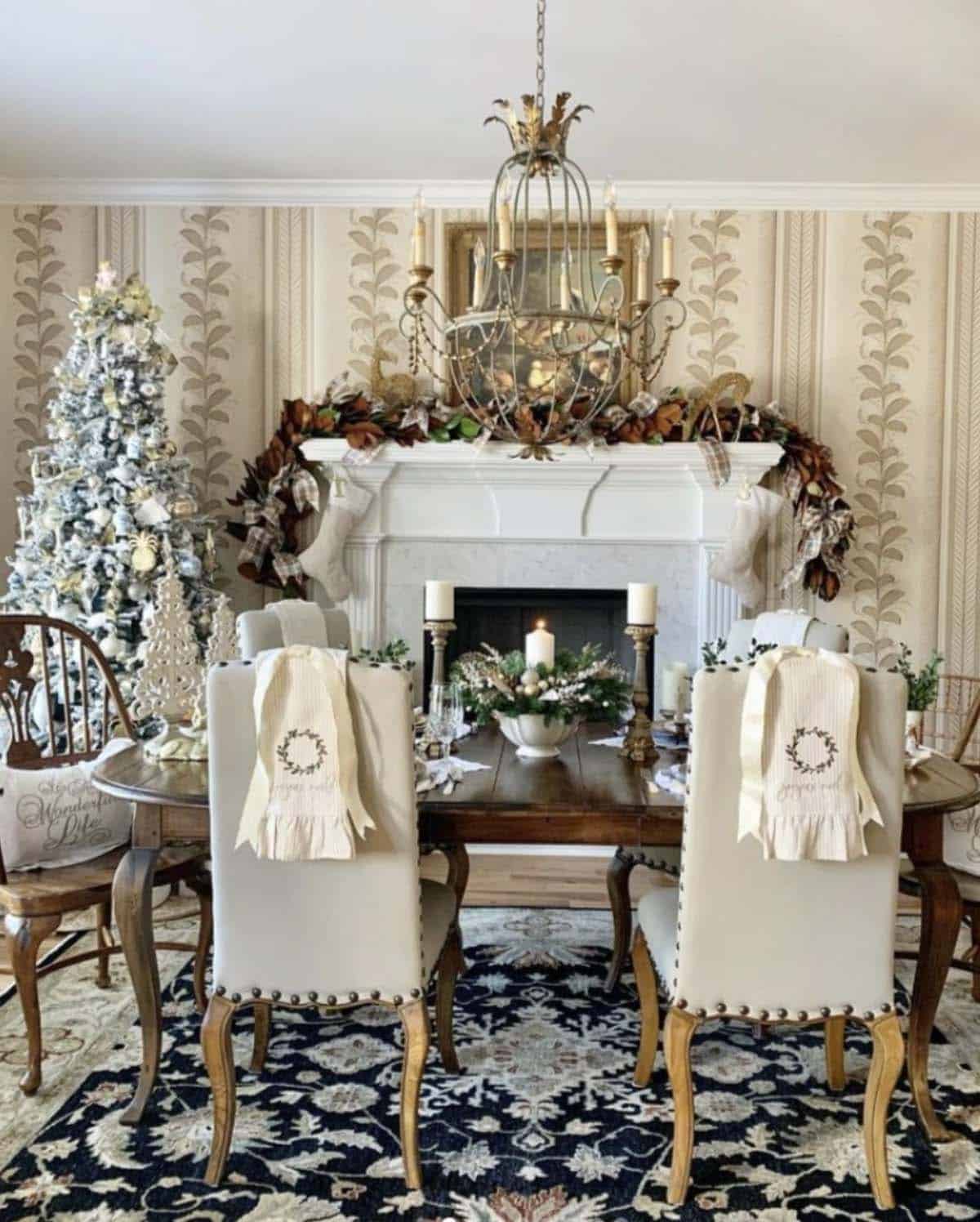 christmas decorated dining room with a fireplace and garland