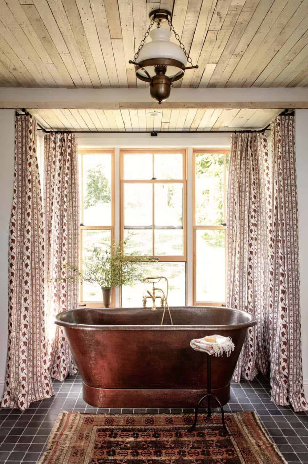 farmhouse bathroom with a freestanding copper tub