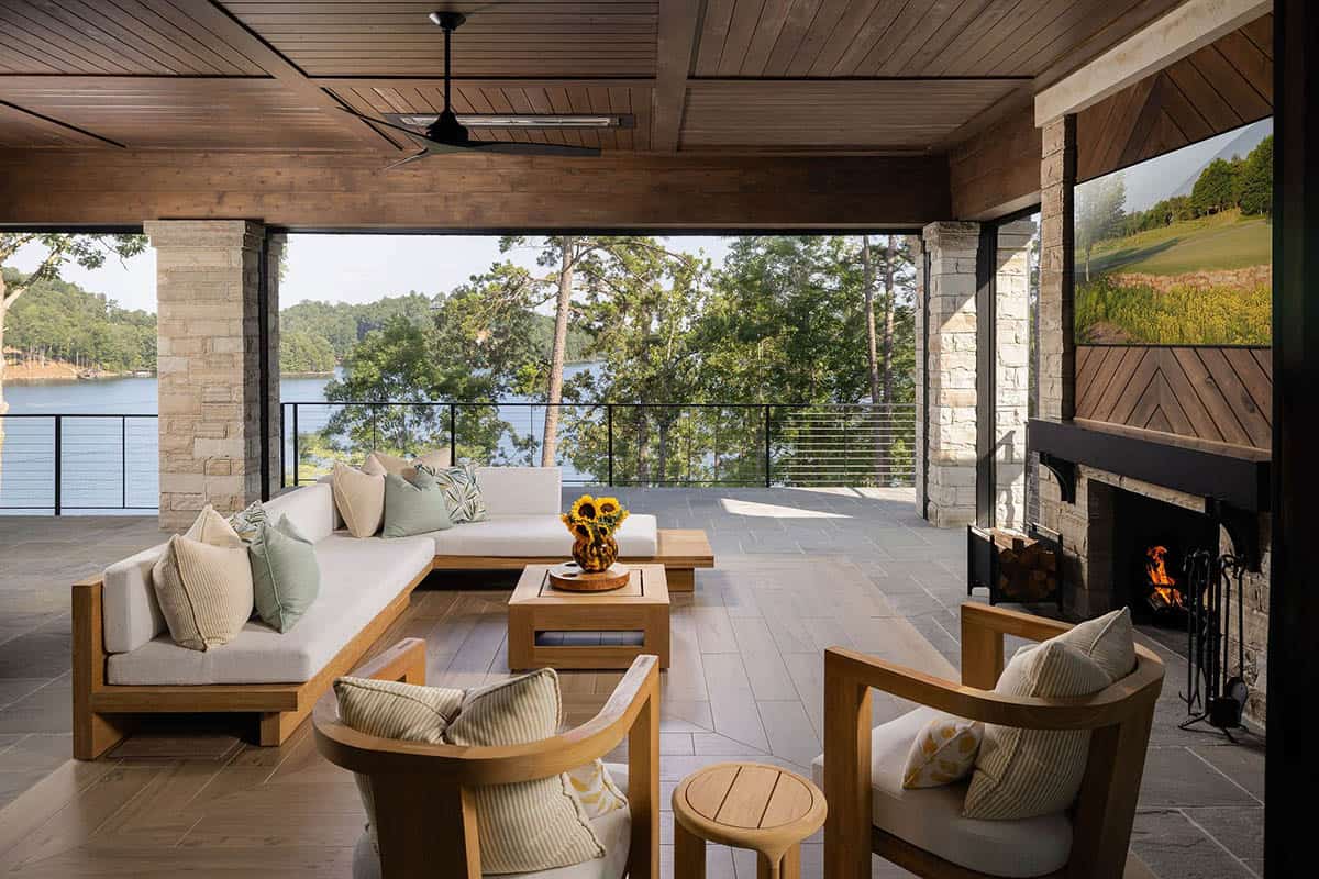 contemporary covered patio with a fireplace overlooking the lake