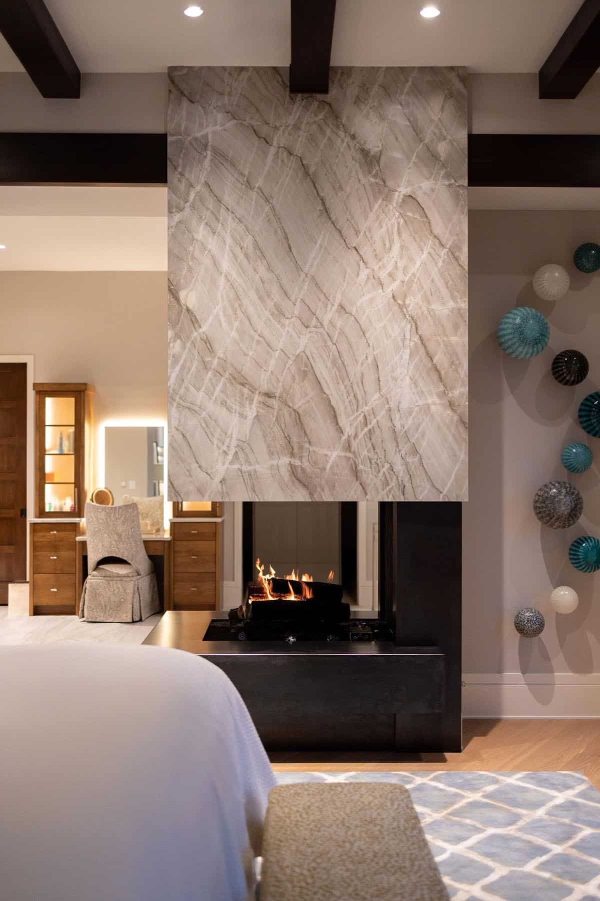 contemporary bedroom with a fireplace at dusk