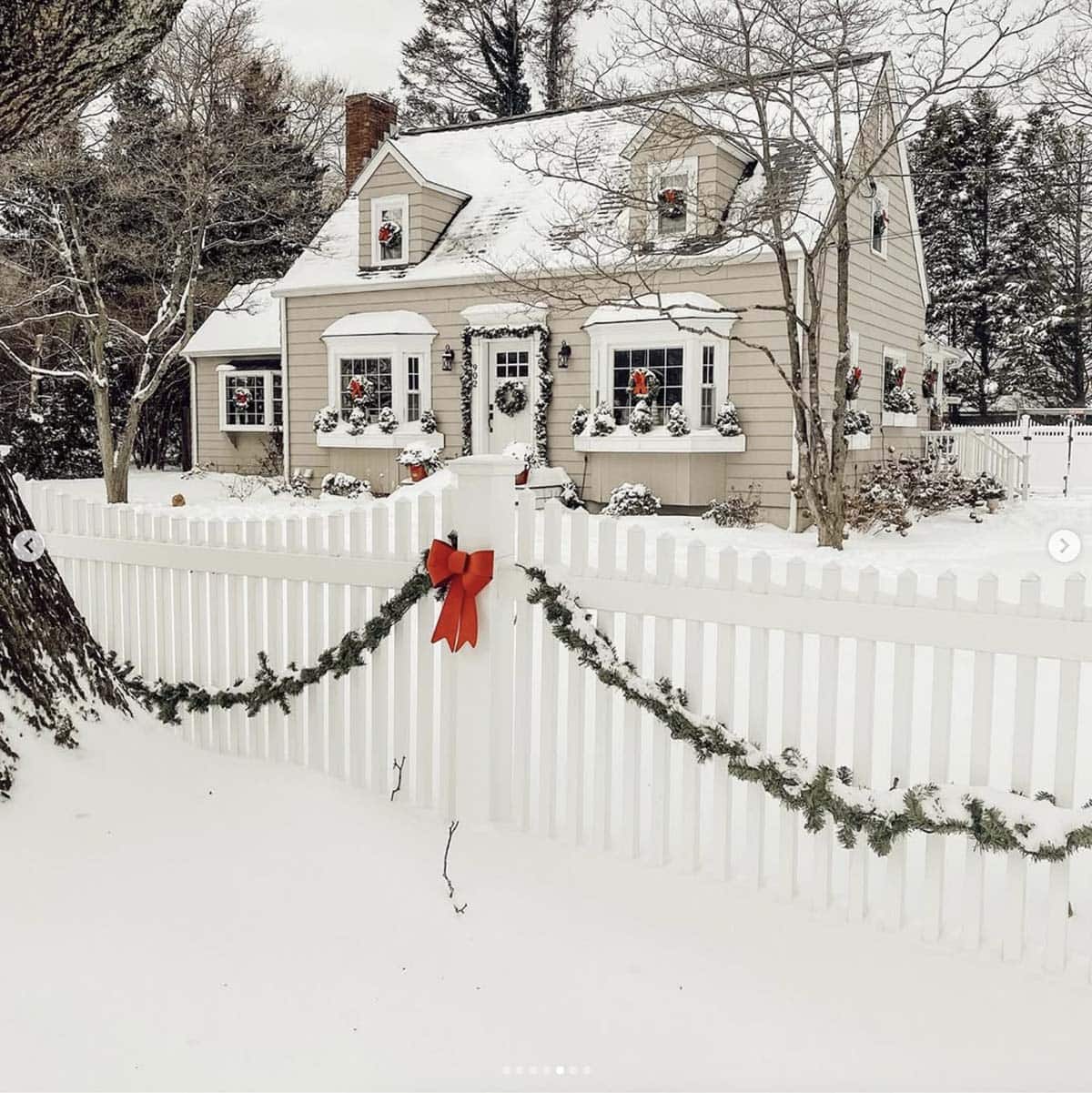 christmas decorated house exterior with snow