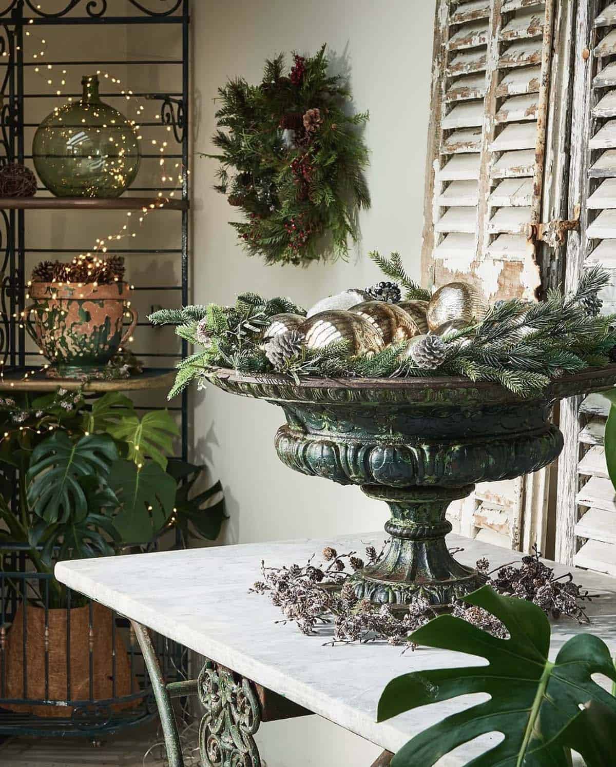 antique urn with christmas ornaments and greenery