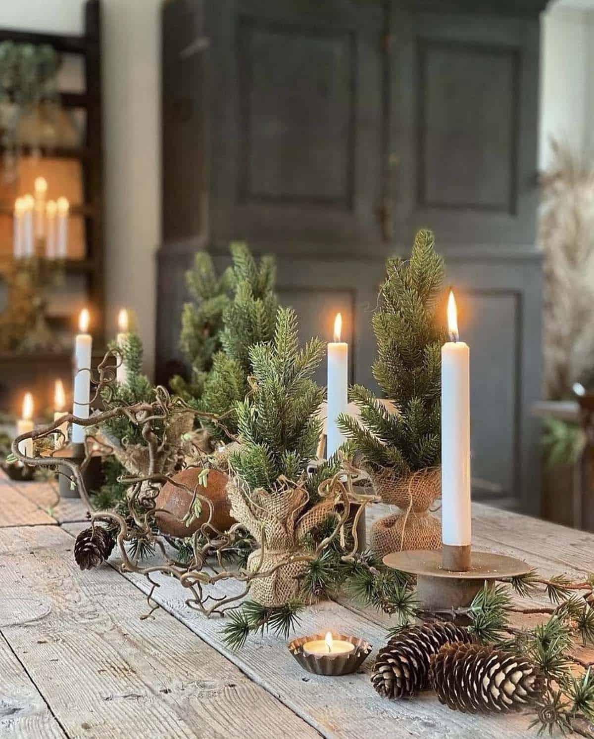 christmas dining table with candles and pinecones