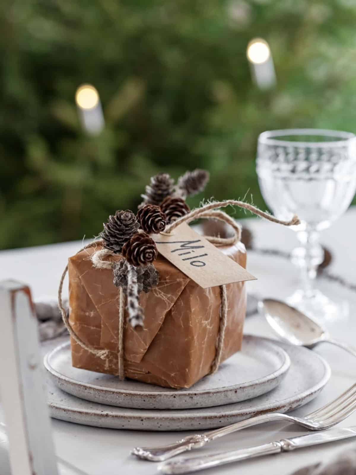 christmas table place setting with a gift