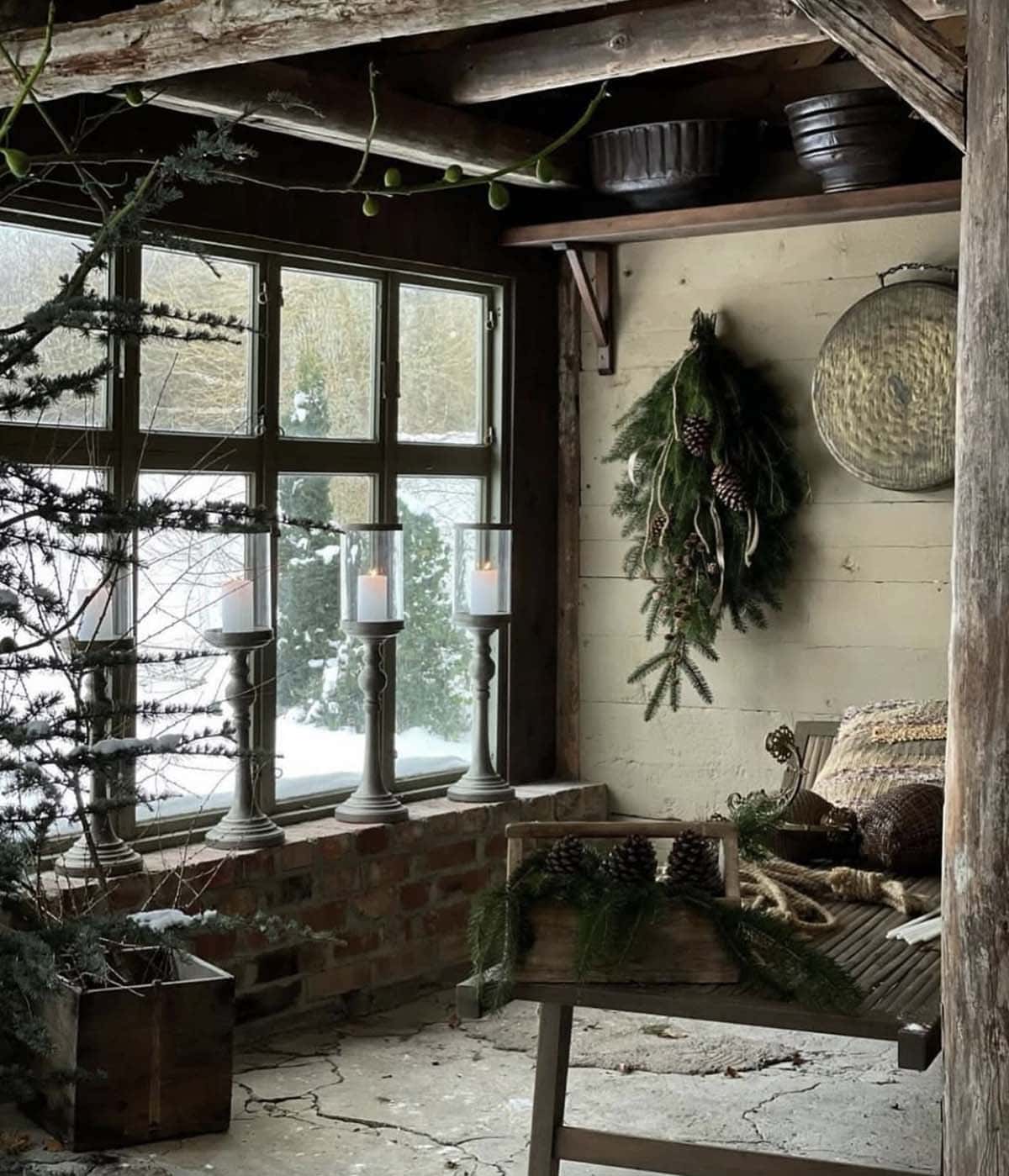 rustic, cozy sunroom with candles and greenery