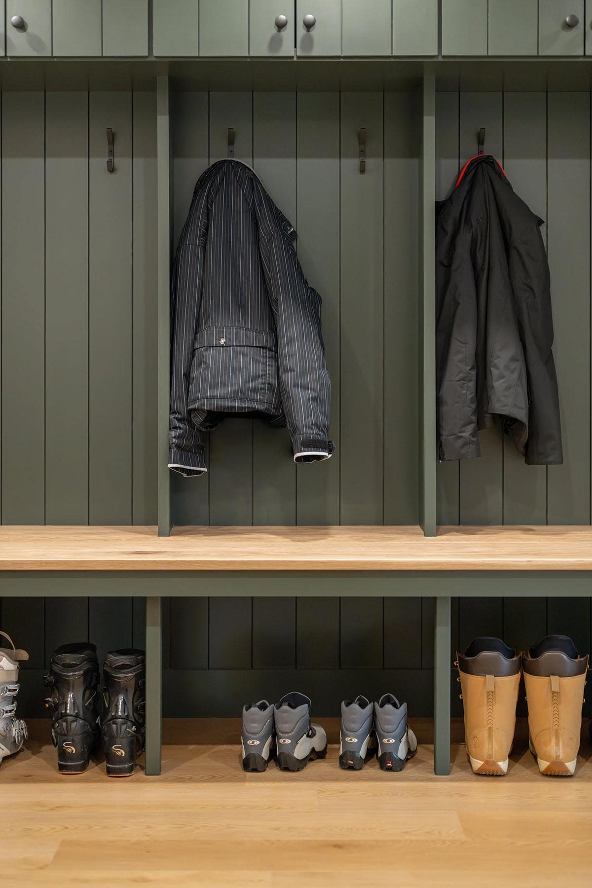 modern mountain style mudroom with a built-in bench
