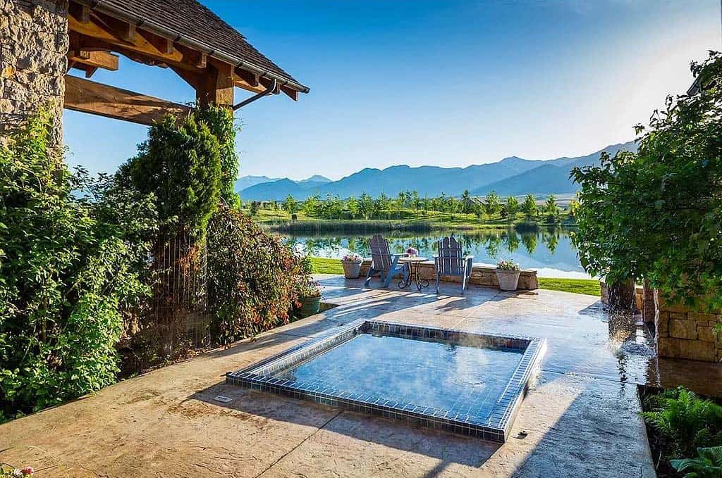 modern rustic mountain home patio with a hot tub