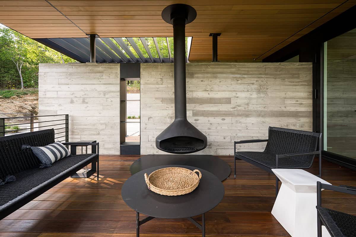 mountain modern home exterior with a covered patio and fire stove