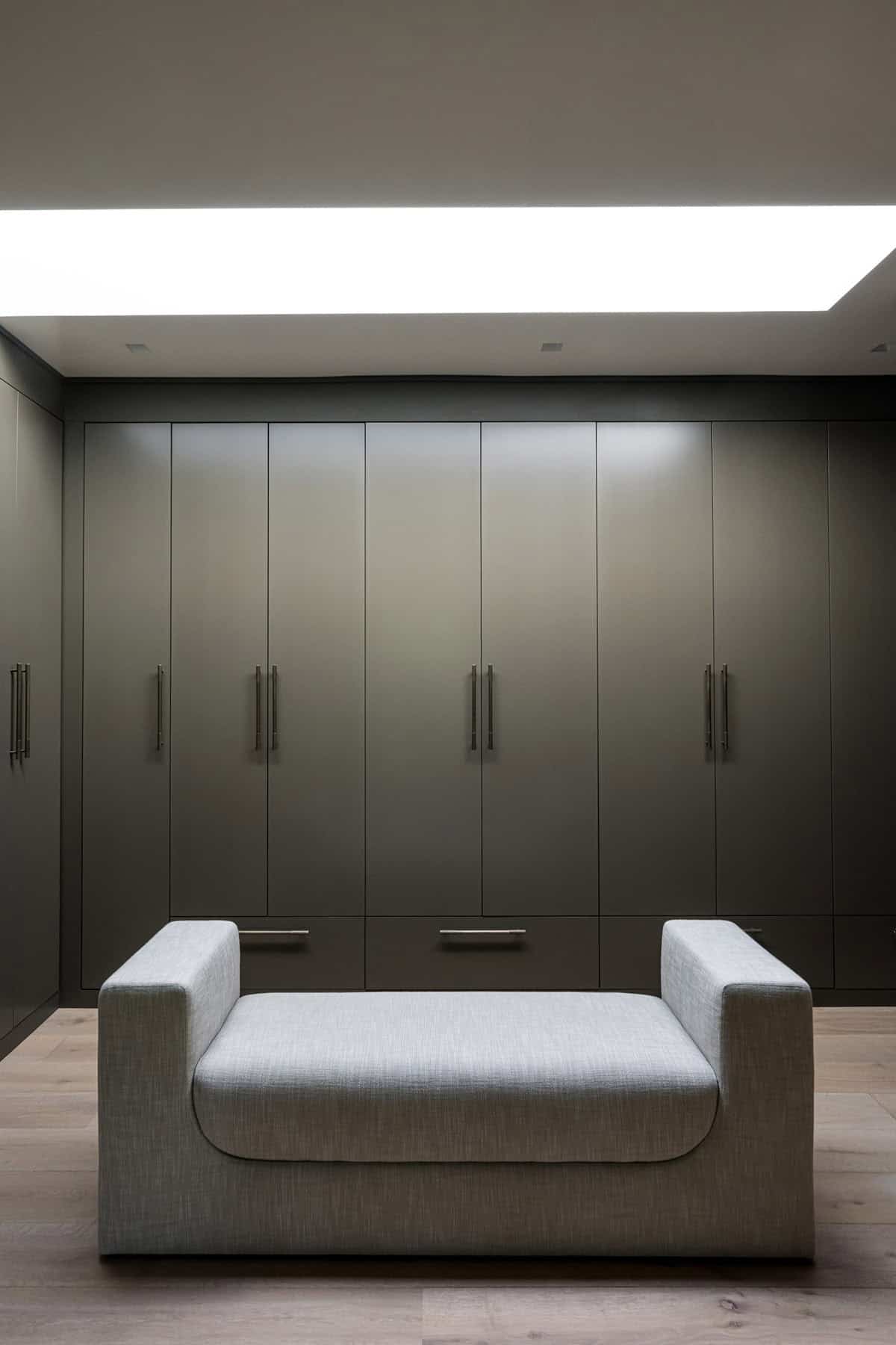 modern closet with a bench