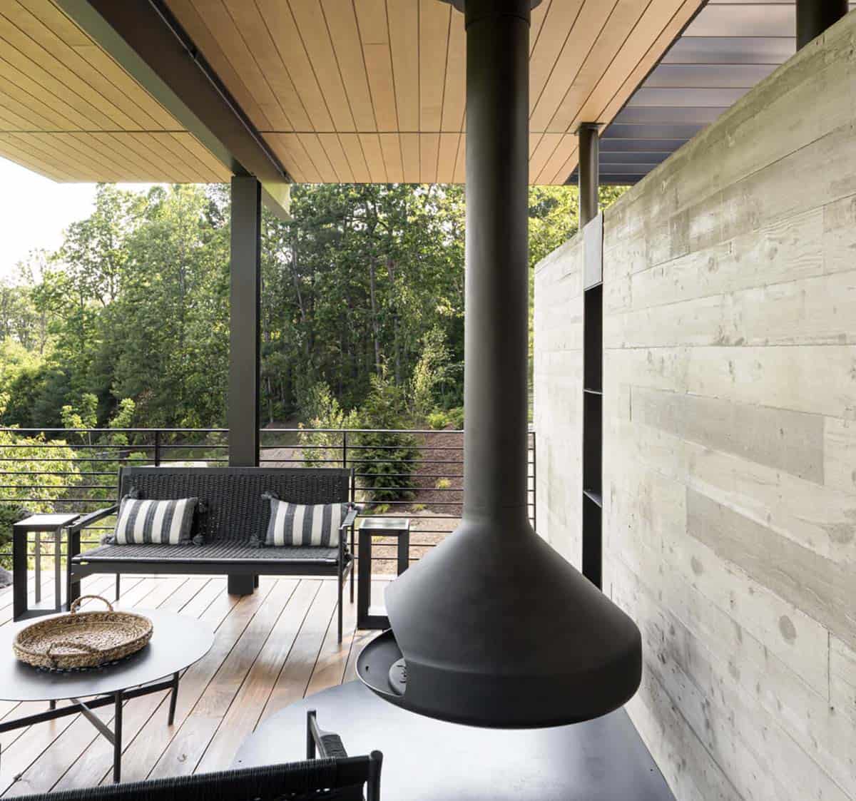 mountain modern home exterior with a covered patio and fire stove