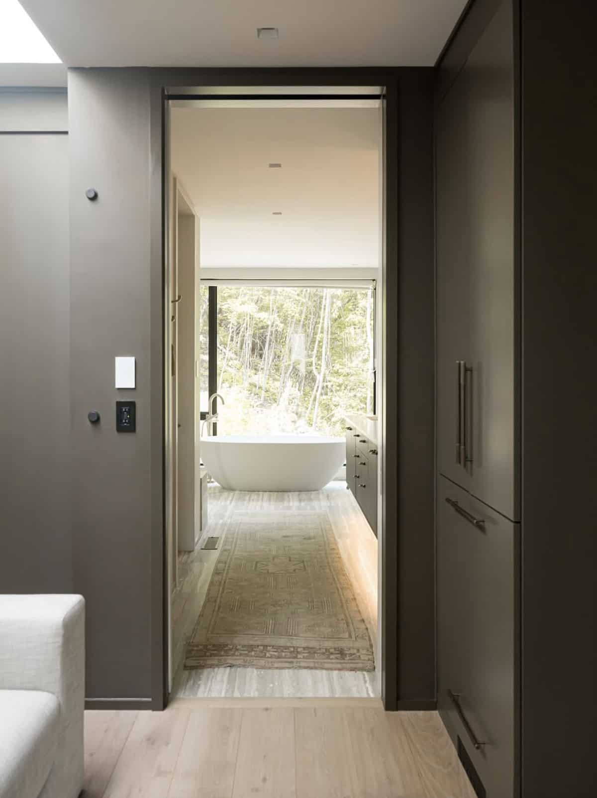 modern walk-in closet leading into the bathroom