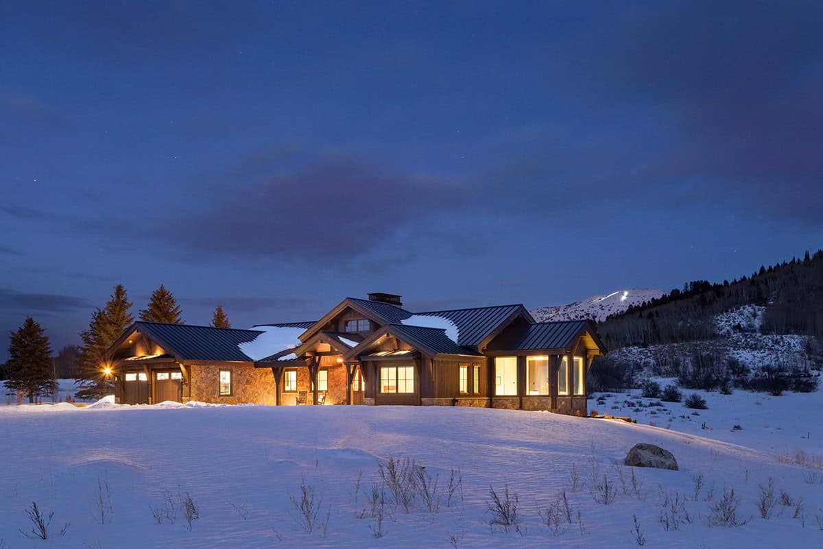 modern mountain home exterior at dusk