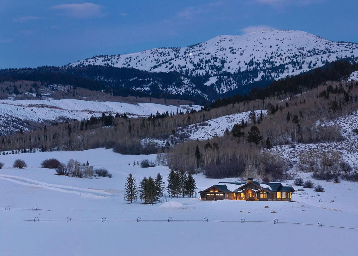 modern mountain home exterior at dusk