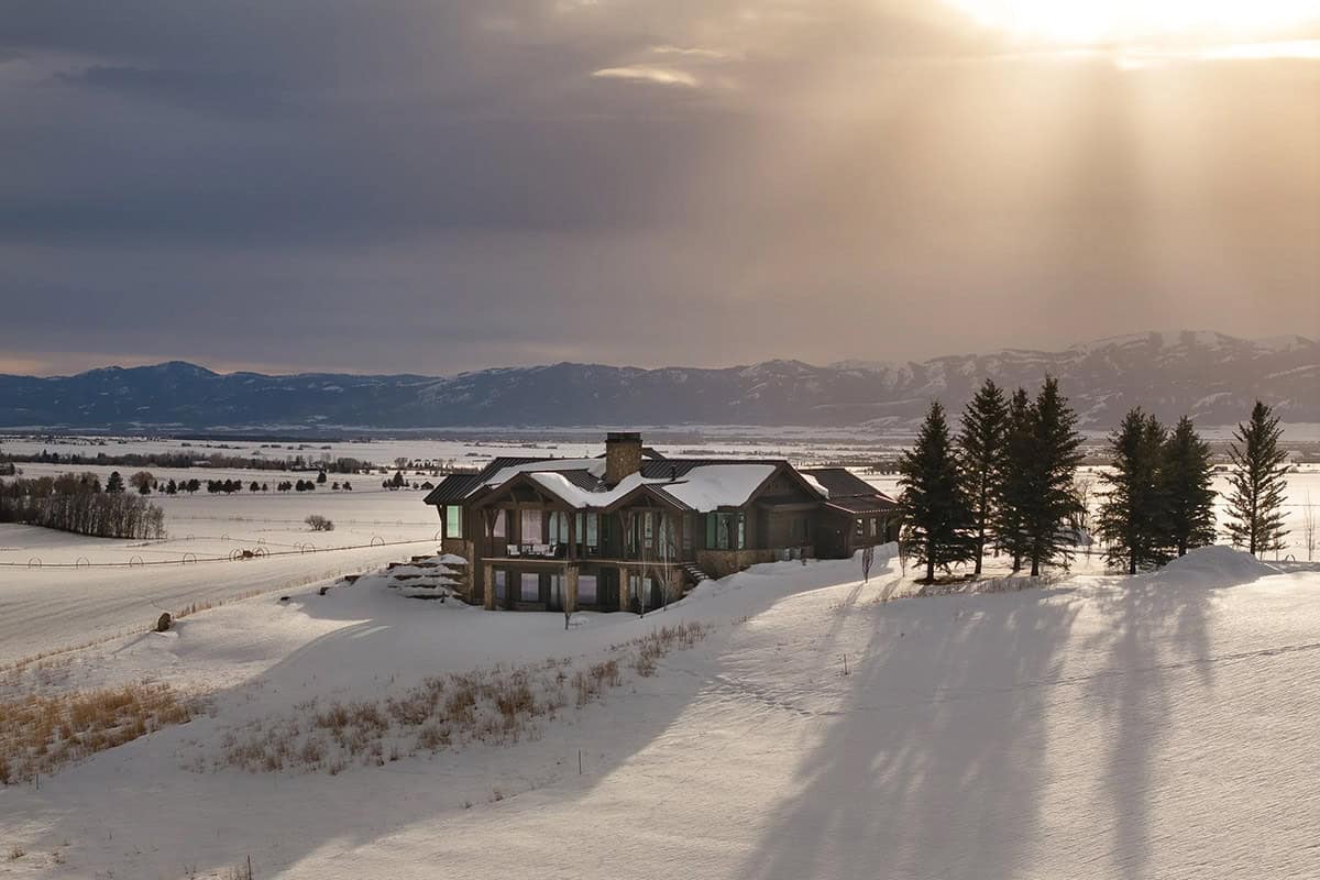 modern mountain home exterior with snow