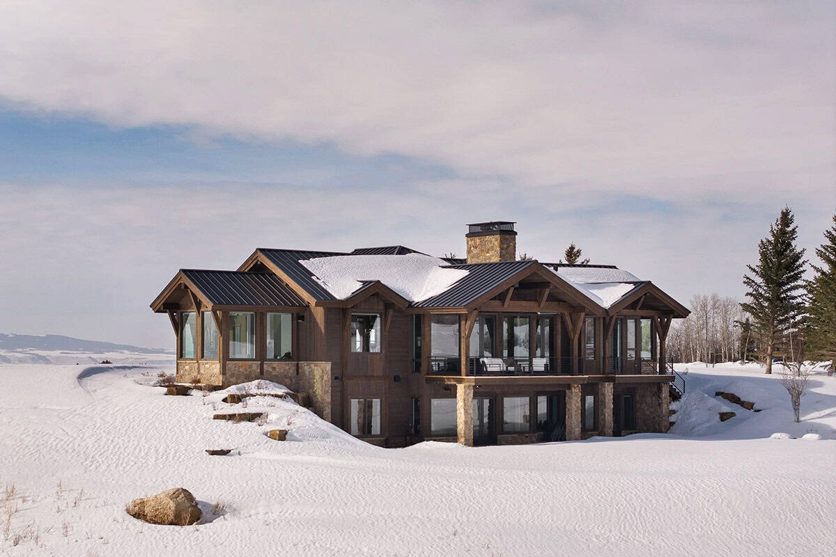 modern mountain home exterior with snow