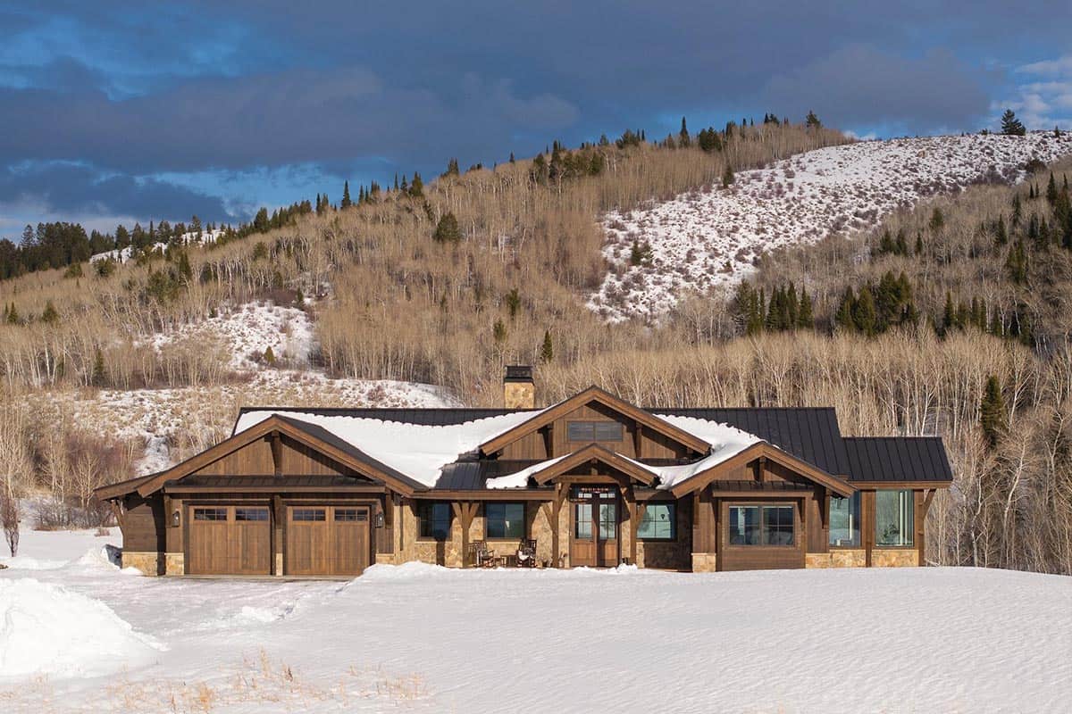 modern mountain home exterior with snow