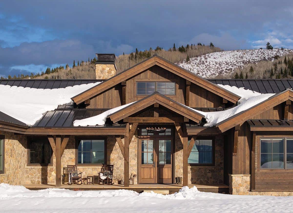 modern mountain home exterior with snow