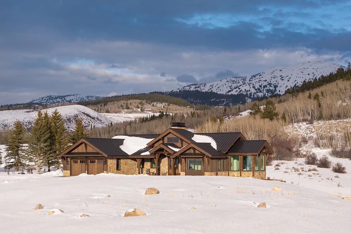 modern mountain home exterior with snow